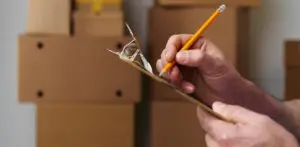 man checking off moving checklist