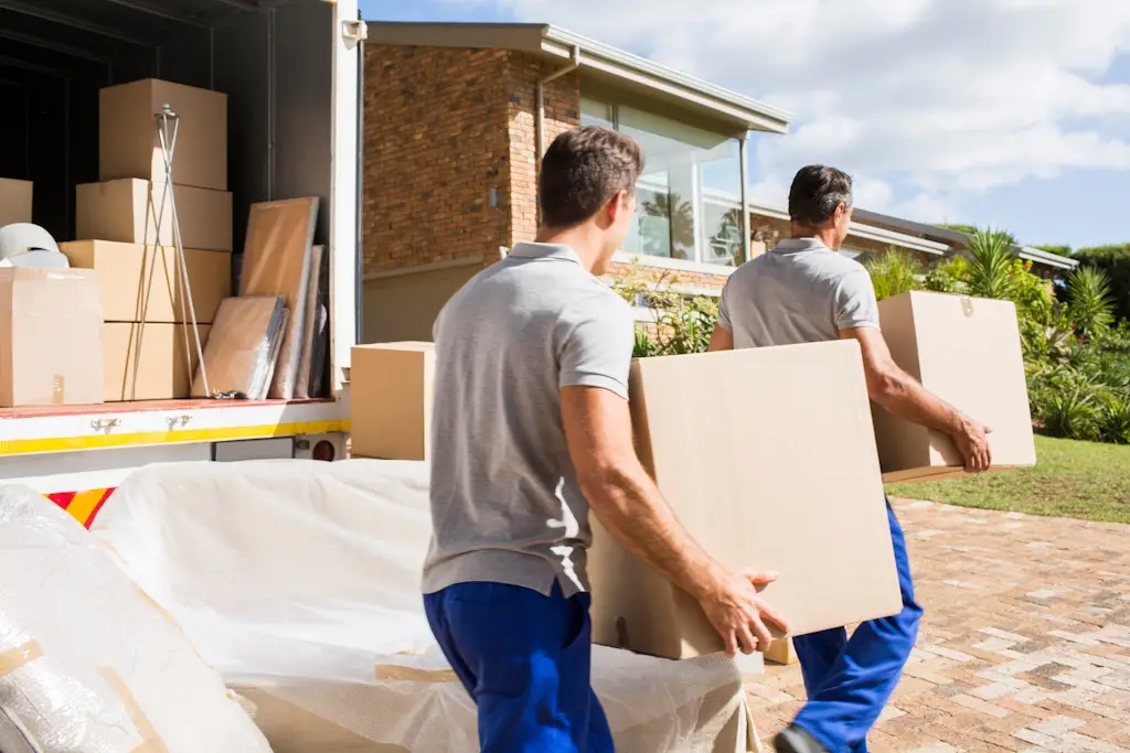 movers moving boxes into home