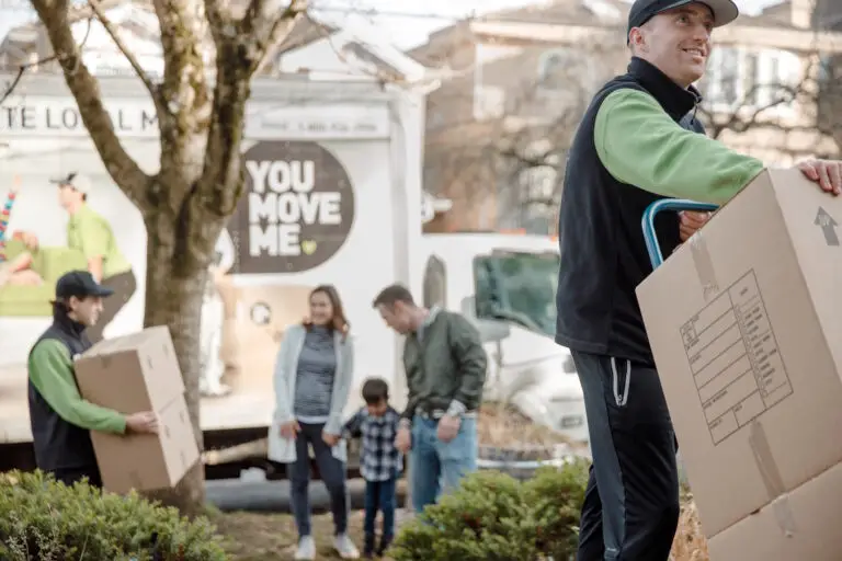 family behind movers at new house