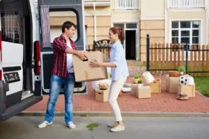 man and woman loading boxes in van
