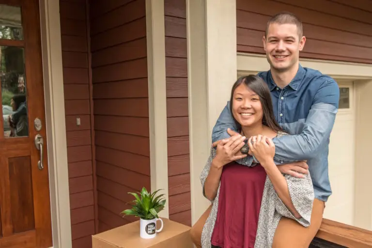 happy couple next to moving boxes