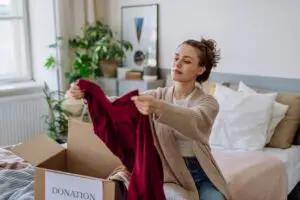 woman decluttering clothes before moving