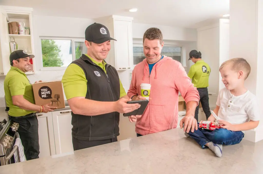 You Move Me team reviewing moving estimate with client