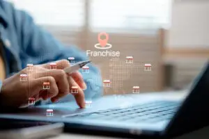 franchise owner graphics over man working on laptop