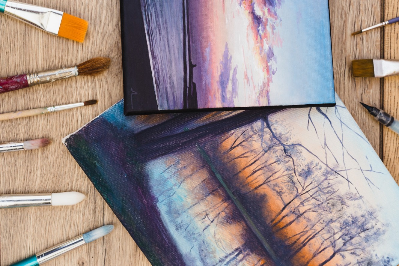 A modern artist's desk with framed paintings prepared for moving
